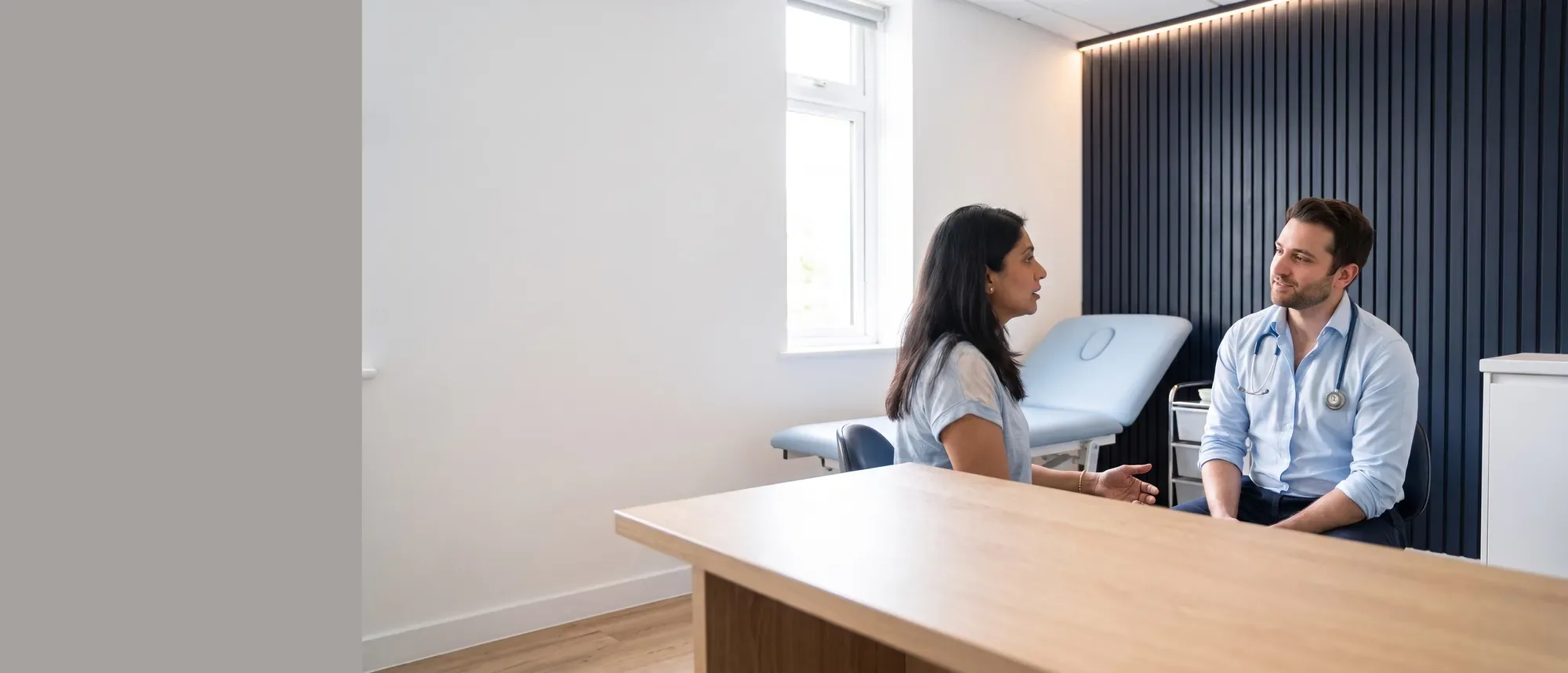 A Niva GP talking with a patient in a consulting room